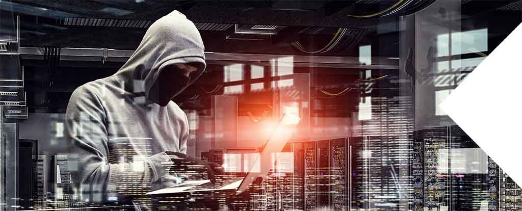 Hybrid IT strategy combats IT sprawl reducing the number of unsanctioned IT deployments - image of shadowy figure hacking into networks.